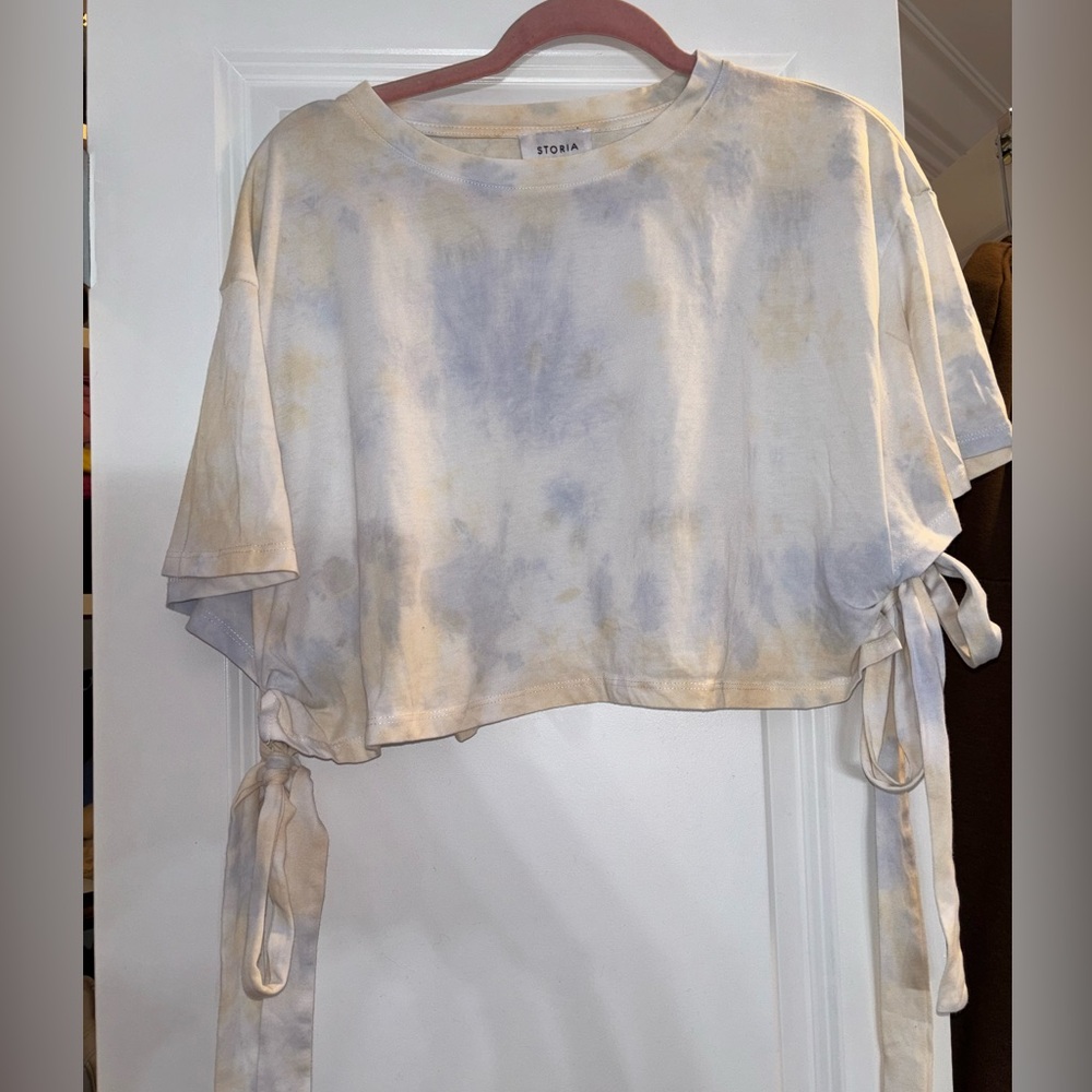 Cream crop top with tie dye blue and ties on the side, storia brand size large